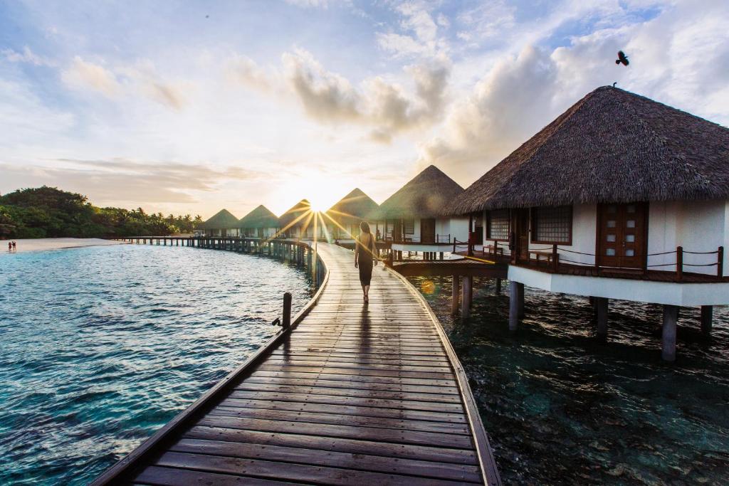 a bridge over the water with a building on it at Adaaran Prestige Water Villas - with Dine around Premium All inclusive - 24 hours in Raa Atoll