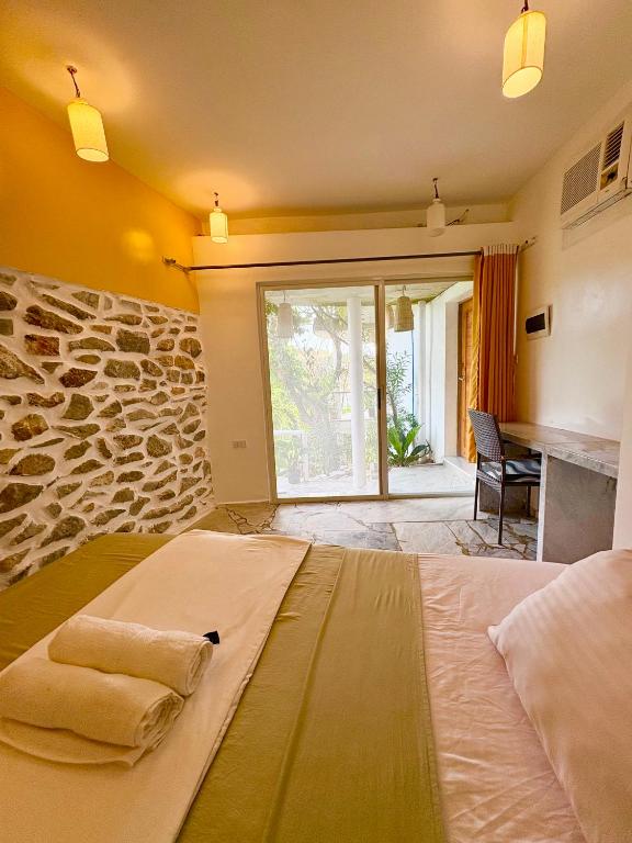 ein Schlafzimmer mit einem großen Bett, auf dem Handtücher liegen in der Unterkunft Lonos Circle Terrace view in Romblon