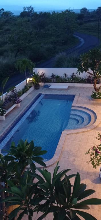 a swimming pool in a yard with a resort at Khrisna Mooi villa 2 BR in Tulamben