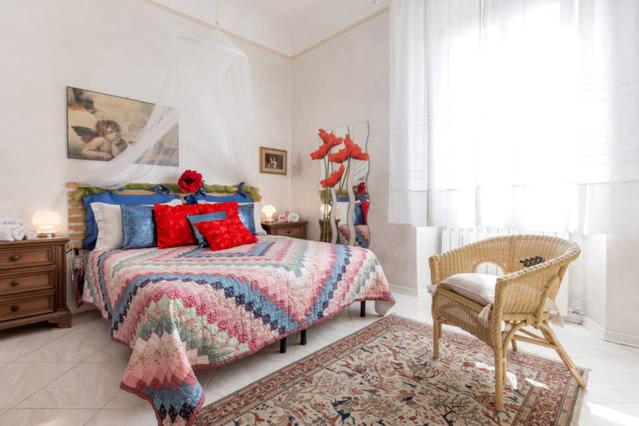 sypialnia z łóżkiem, krzesłem i oknem w obiekcie Oasi di pace we Florencji