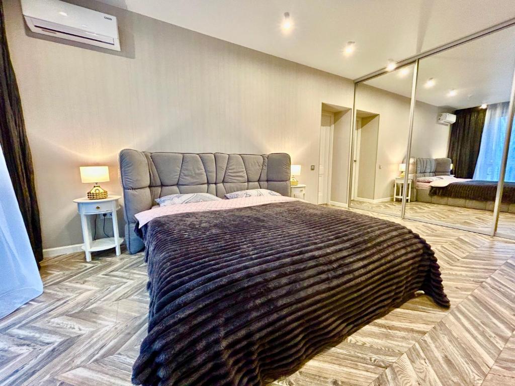 a bedroom with a large bed with a large mirror at Designer luxury Appartment in Kharkiv