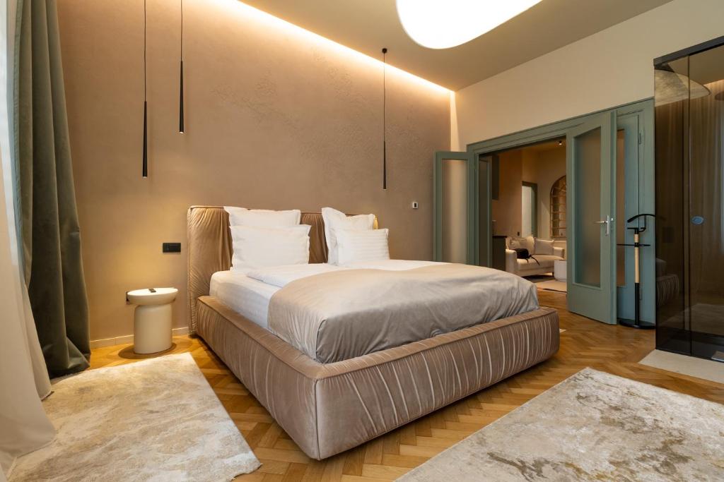 a bedroom with a bed with white sheets and pillows at The Rabbit Citadel in Sibiu