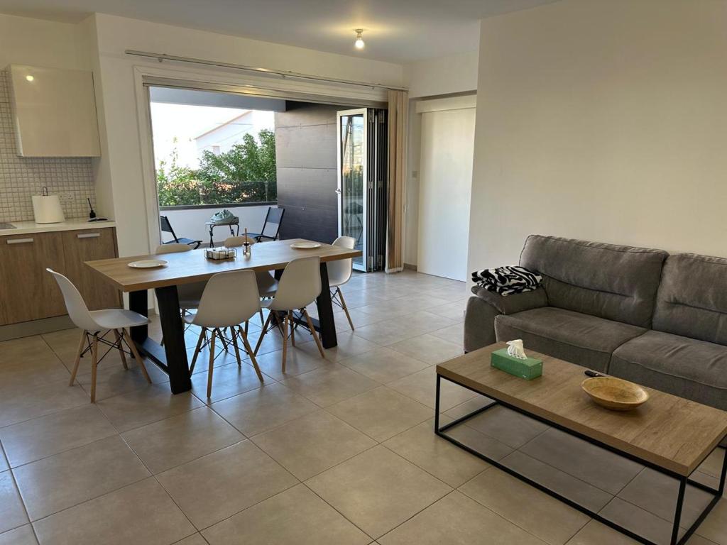 a living room with a couch and a table at Two Bedrooms Apartment with Private Balcony in Yukarı Lakatamya