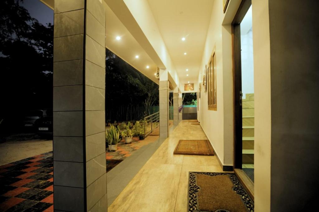 a hallway of a house with a view of the yard at Dolphins Turf in Mararikulam