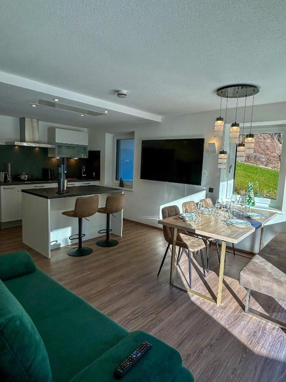 a living room with a green couch and a table at MOUNTAIN HOME apartment in Finkenberg