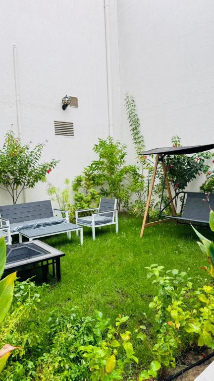 a yard with benches and a gazebo at Neem Premium Villa in Al Jubayl