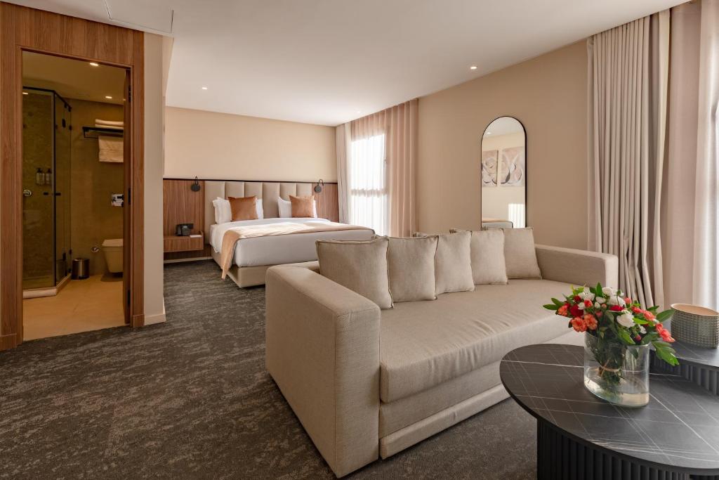 a hotel room with a couch and a bed at Citadines Almaz Aparthotel Casablanca in Casablanca