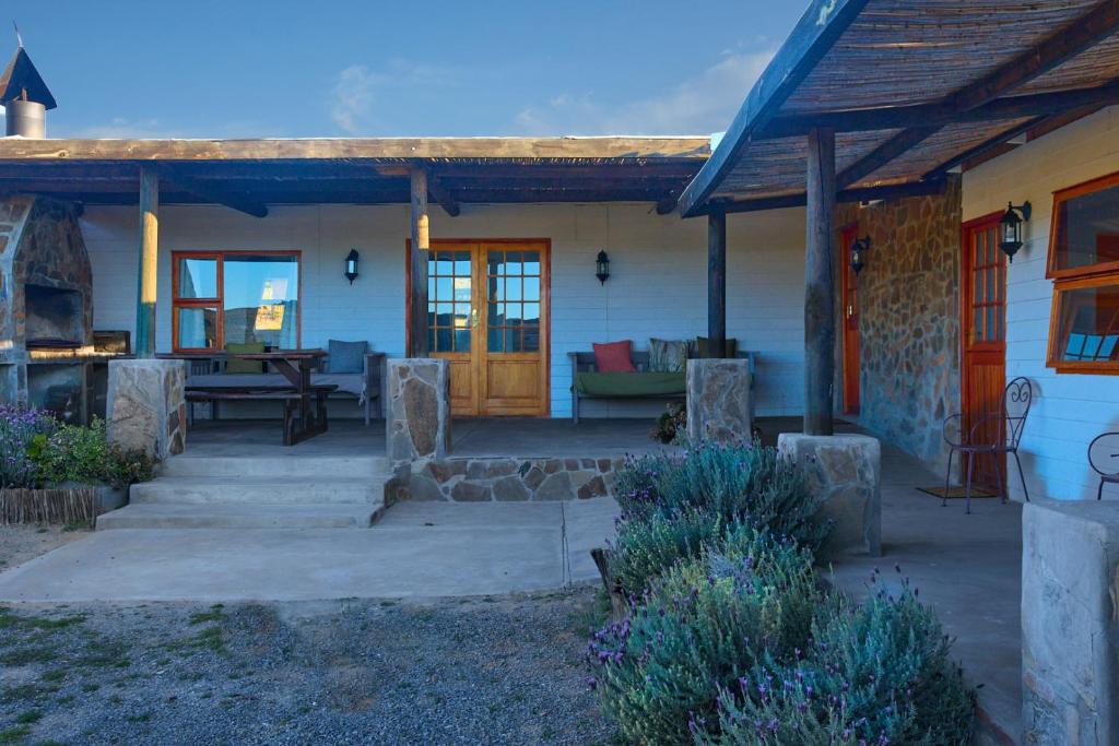 a house with a porch and a patio at Jagerskraal Guest Farm in Laingsburg