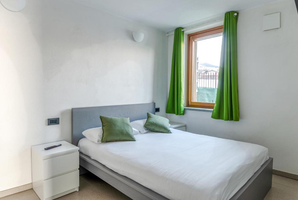 En eller flere senge i et værelse på Aosta Holiday Apartments - Charvensod