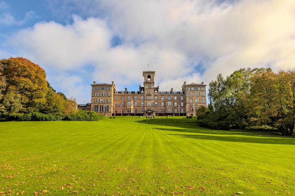 a large building with a grass field in front at Apex Dunblane Hydro in Dunblane