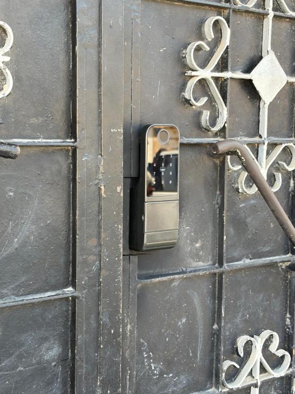 a metal doorhandle on a wooden door at Sikka Hostel in Muscat