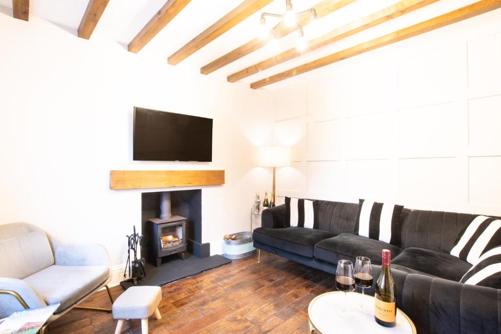 a living room with a couch and a fireplace at Northern Hideaways St Cuthberts, Seahouses in Seahouses