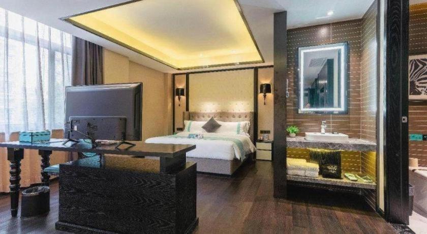 a bedroom with a bed and a desk and a sink at Xana Hotelle·Shanghai Expo Park Xizang Nan Road in Shanghai