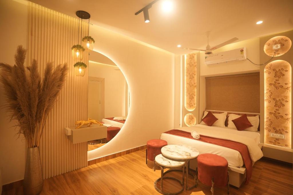 a bedroom with a bed and a round mirror at Meghnad By Padmaraag in Nalbāri