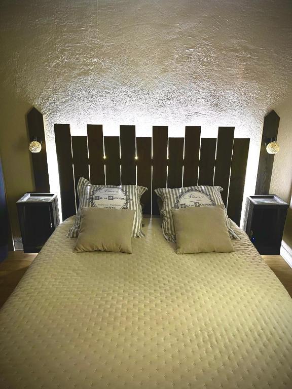 a bedroom with a large bed with two pillows at Le Charmant Paillot Hyper Centre classé in Troyes