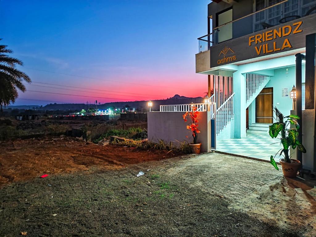 a building with a sign that reads fraud villa at night at Friendz Villa in Igatpuri