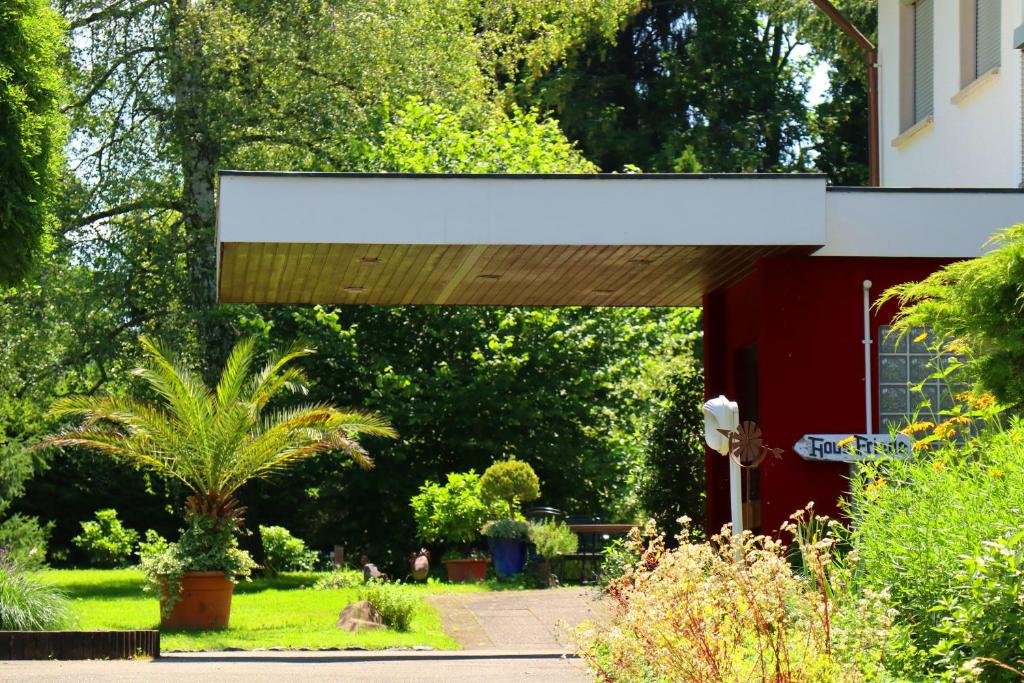 awning over the entrance to a red building at Landhaus Friede in Müllheim