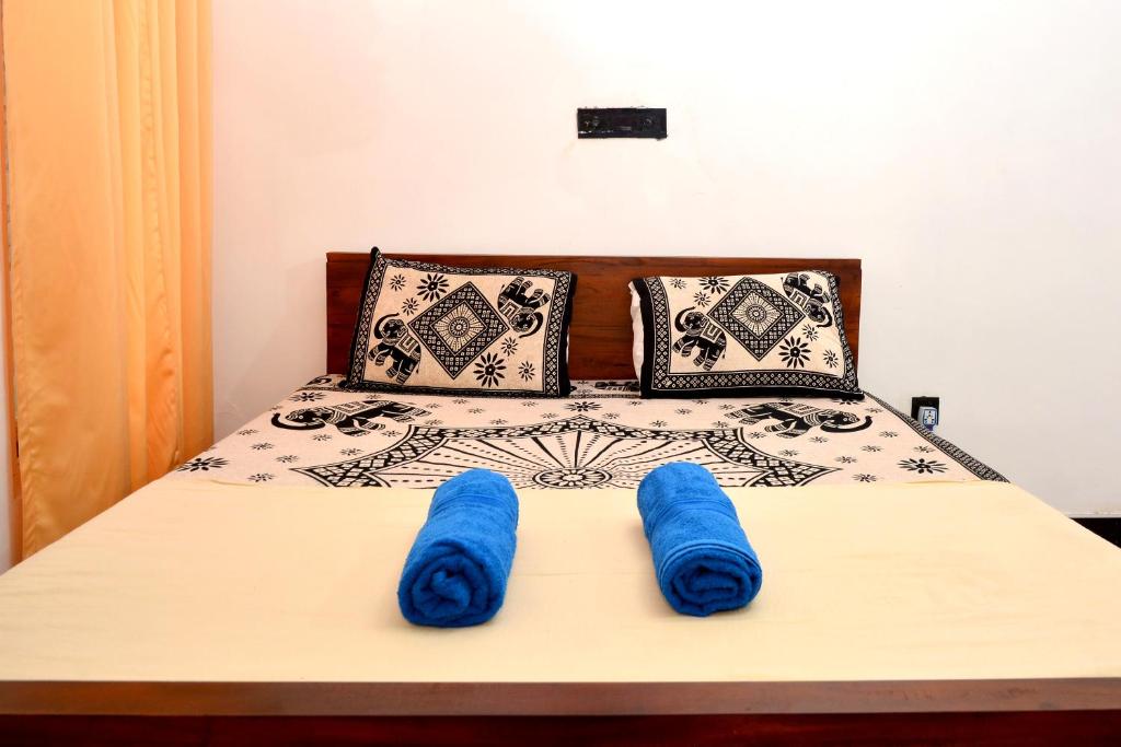 Ένα ή περισσότερα κρεβάτια σε δωμάτιο στο Royal Residence Negombo