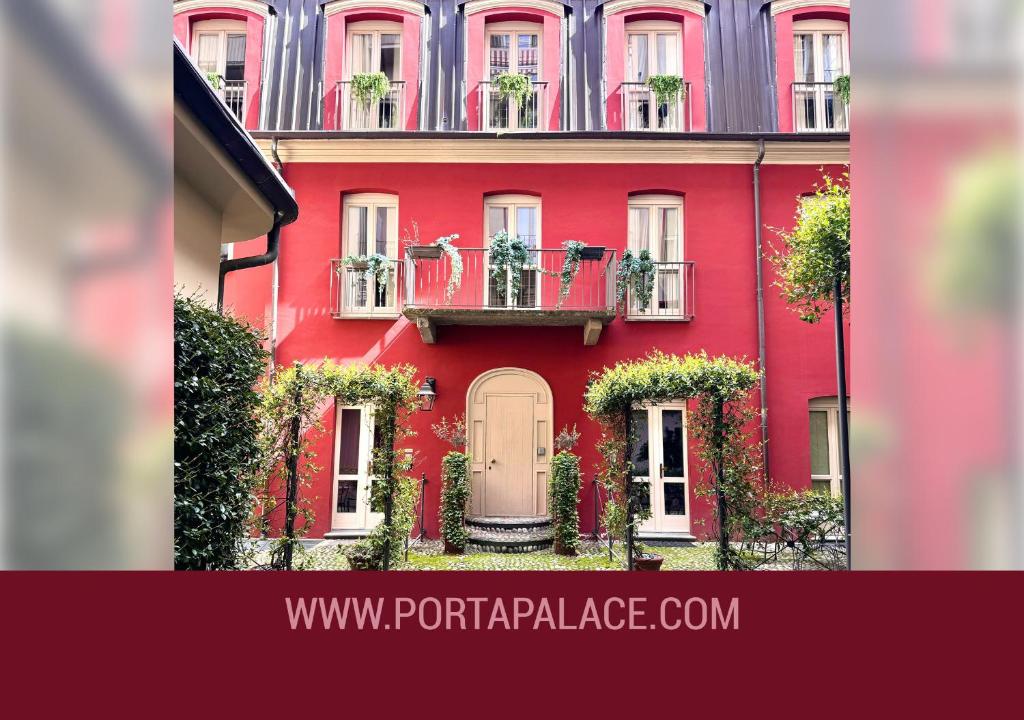 a red building with flower boxes and a balcony at Porta Palace Apartments in Turin