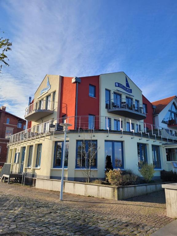 a building with balconies on the side of it at Pension Hafenblick in Barth