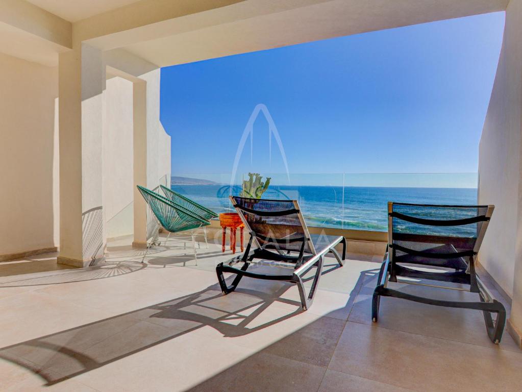 two chairs in a room with a view of the ocean at Illy - Ocean by Coralia - 4 Px in Taghazout