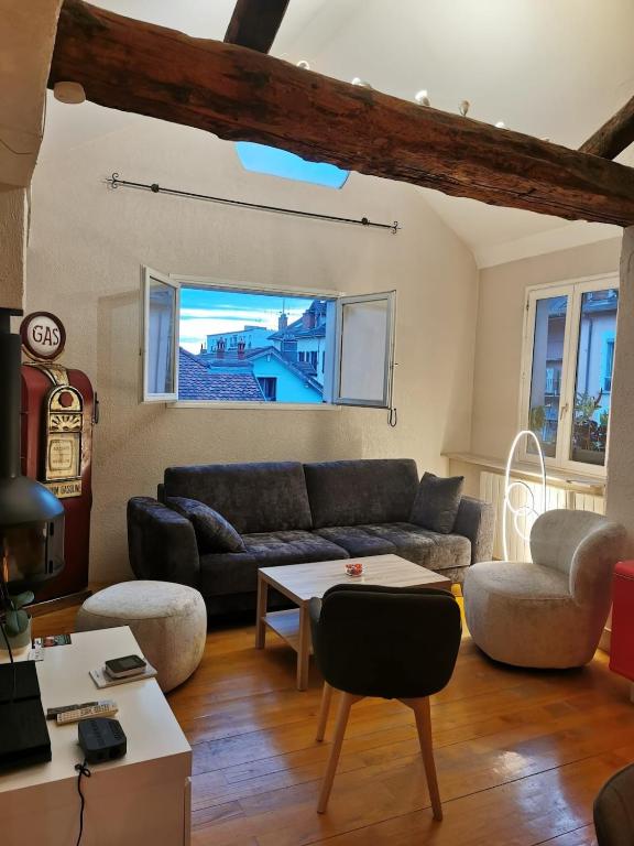 a living room with a couch and a table at Annecy Carnot in Annecy