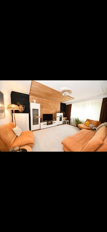 a bedroom with two beds and a living room at Bondar Residence in Galaţi