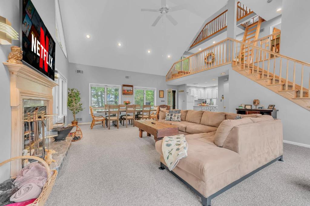 a living room with a couch and a table at Large Family Friendly House on the Fairway Hideout in Lakeville