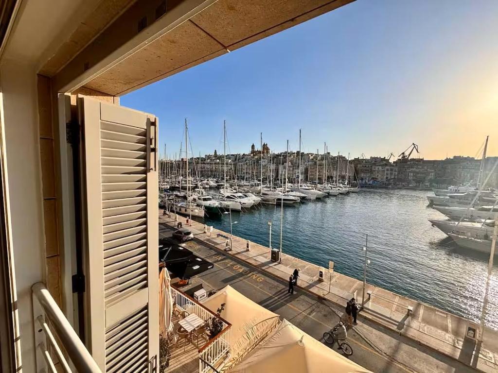 a view from a balcony of a marina with boats at Birgu Seafront 3 Bedroom Apartment in Vittoriosa