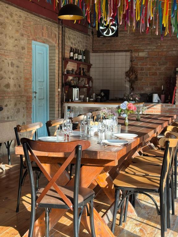 a long wooden table in a restaurant with chairs at Nikalas Marani in Gurjaani