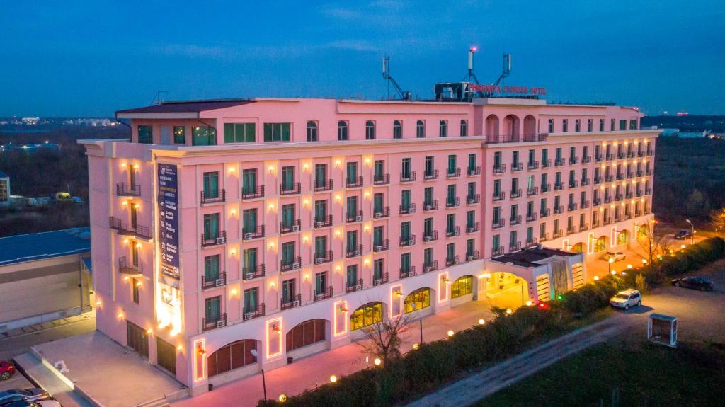 a large white building with lights on it at night at Phoenicia Express Hotel in Bucharest