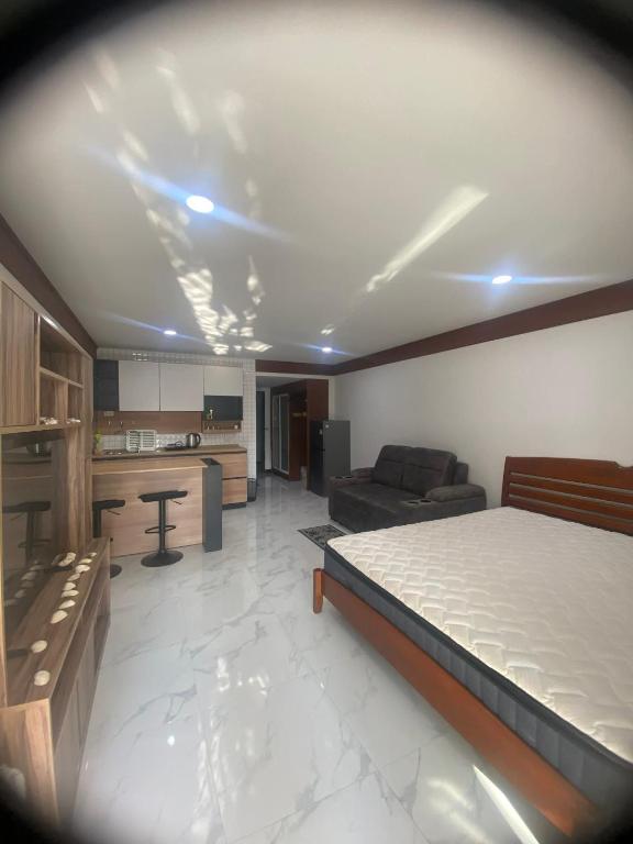 a living room with a bed and a kitchen at Sea Sand Sun Condominium in Ban Bang Nok