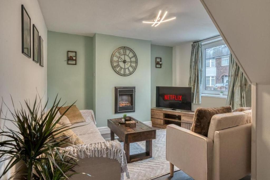 a living room with a couch and a fireplace at Stylish 2BR Cottage Pet-Friendly with Free Parking in Partington