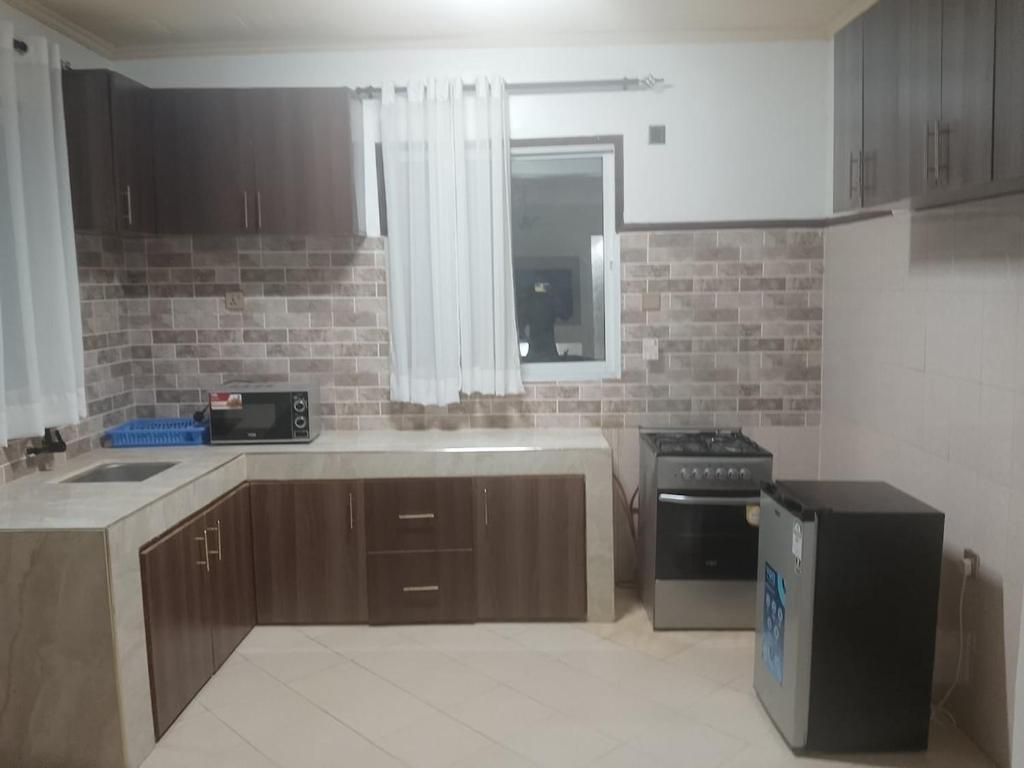 a kitchen with a sink and a stove at majaoni villa in Mombasa