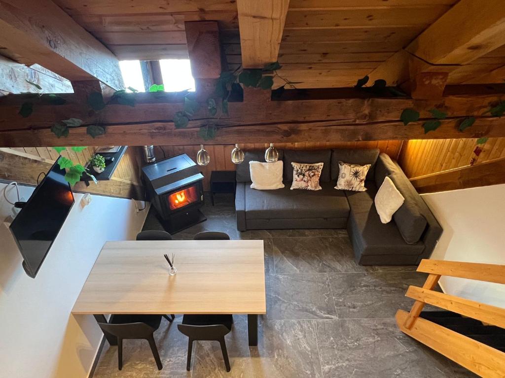 an overhead view of a living room with a table and a stove at Dinastia Case Snow Apartment in Passo del Tonale