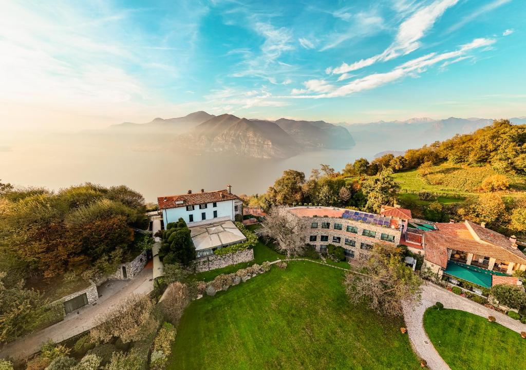 an aerial view of a house on a hill with mountains at Relais I Due Roccoli in Iseo