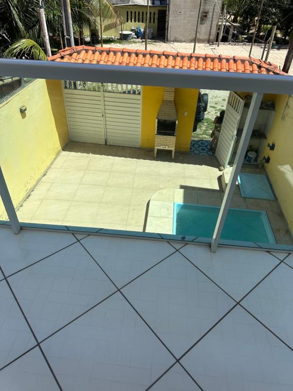 a view of a patio from the roof of a house at CASA DE PRAIA COM PISCINA EM ILHÉUS-BA a 50m DA PRAIA in Ilhéus