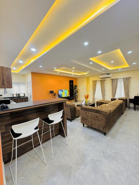 a living room with a couch and a table at StayatMargarets in Abuja