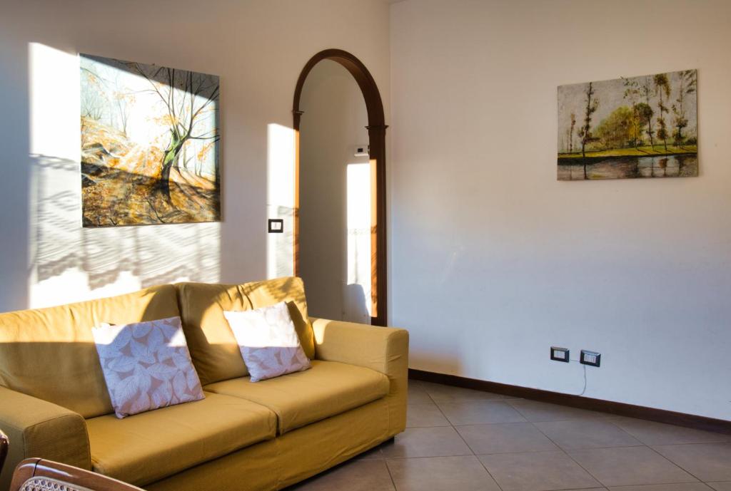 un soggiorno con un divano e un quadro sul muro di Terrazza Alpina in centro Barzio a Barzio