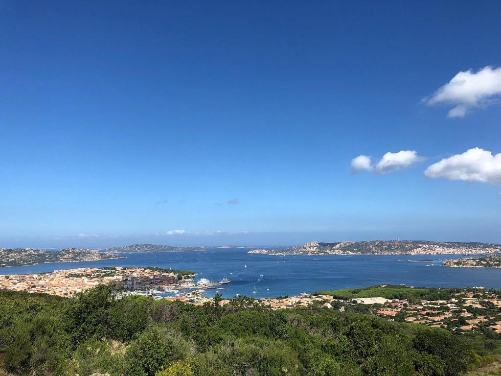 a view of a city and the ocean from a hill at Appartamenti Baia Smeralda in Santa Marinella