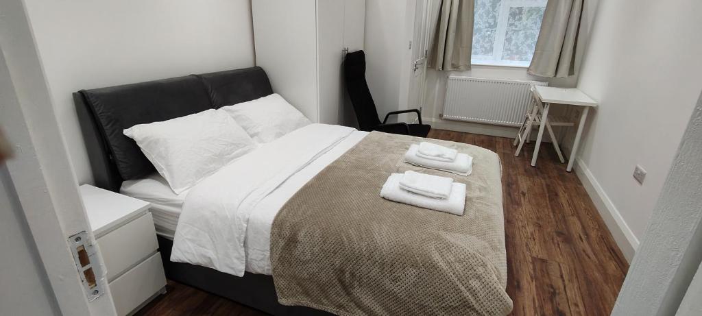 ein Schlafzimmer mit einem Bett, auf dem zwei Handtücher liegen in der Unterkunft Woodrow close in Perivale