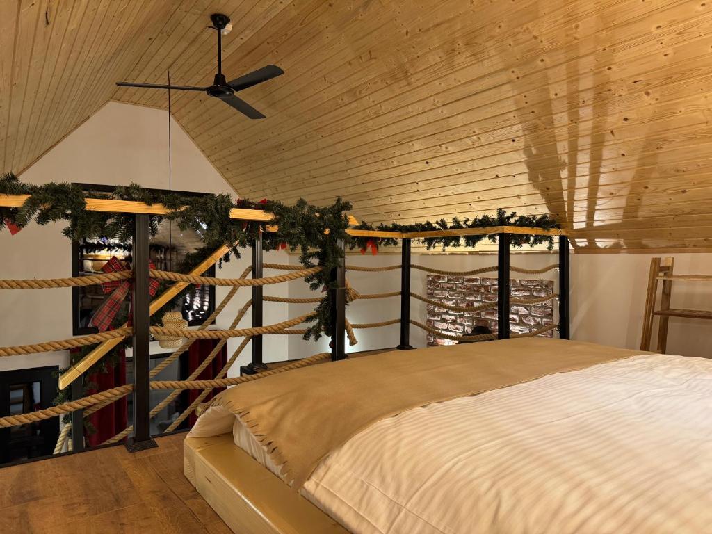 a bedroom with a bed and a wooden ceiling at Kolibe Doftana in Trăisteni