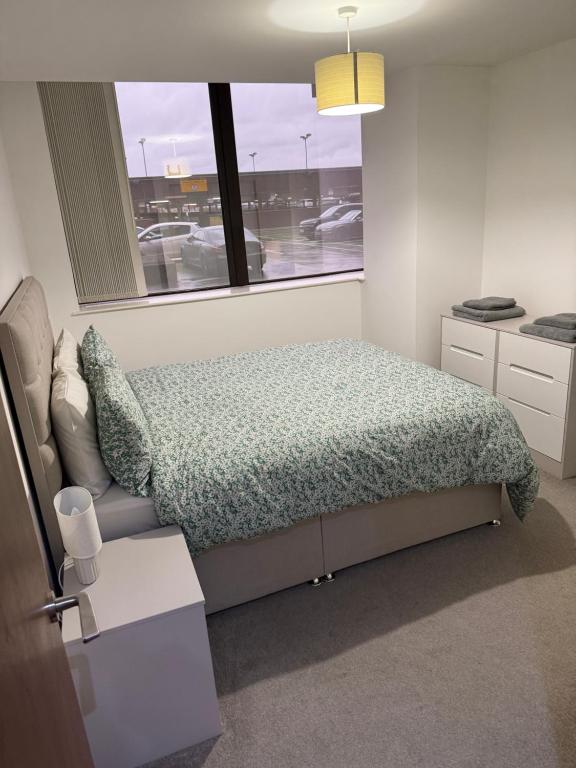 a small bedroom with a bed and a window at 505 City Centre Stylish Double Apartment in Birmingham