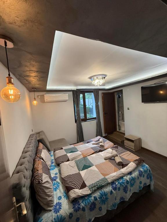 a bedroom with a large bed in a room at Guest House MARAVILA in Belogradchik