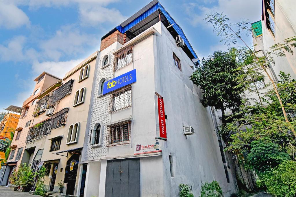 a building with a blue sign on the side of it at FabHotel Rajdanga Retreat in Kolkata