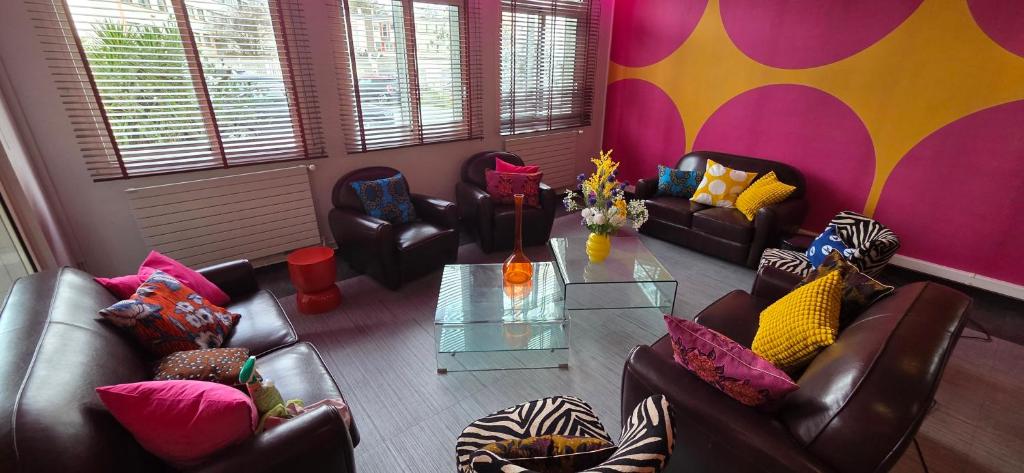 a living room with two couches and a table at Smartappart Lorient in Lorient