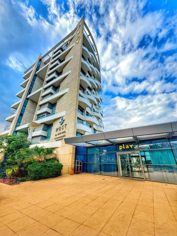 a large building with a parking lot in front of it at Play Hatzuk Beach in Tel Aviv