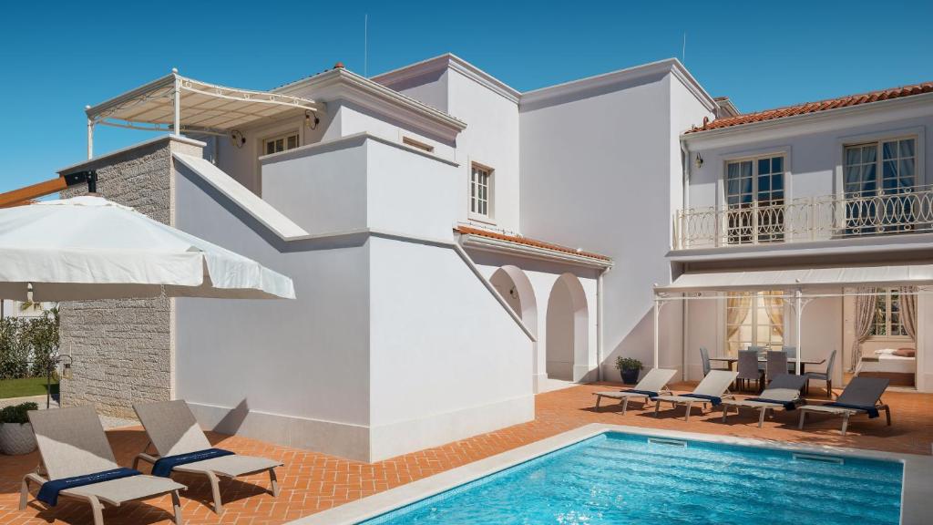 a villa with a swimming pool and patio furniture at Luxury villa Adele with pool in Porec in Vabriga