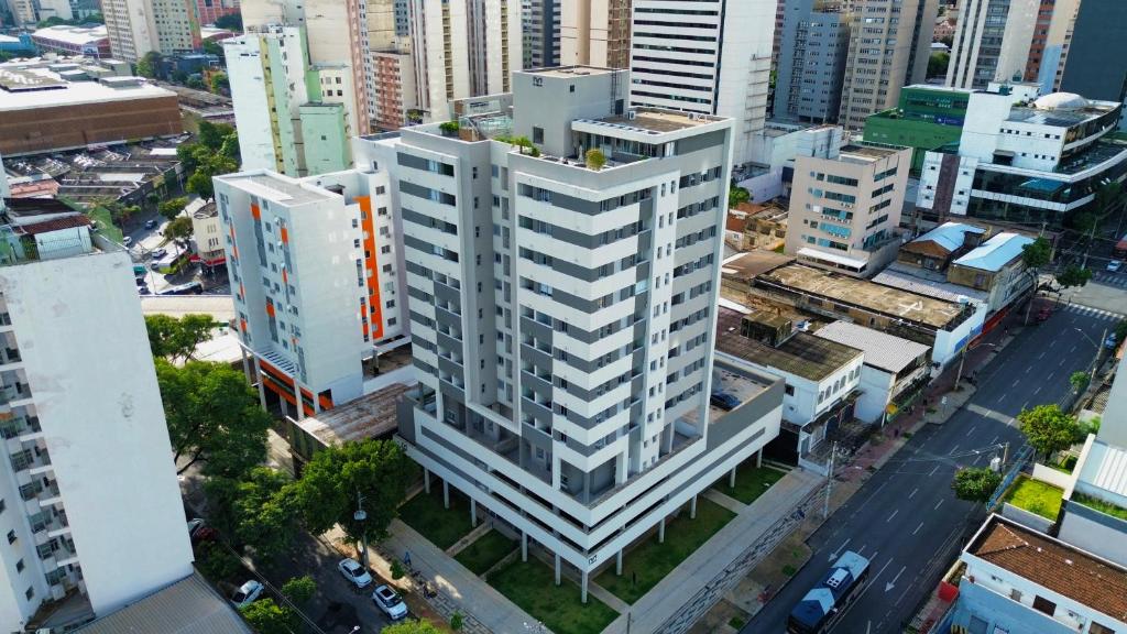 an overhead view of a tall white building in a city at Tupis Flats 1401 in Belo Horizonte