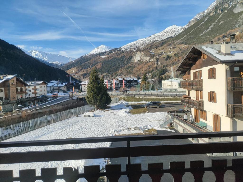 a view from a balcony of a town with snow covered mountains at Casa del Capitano Hilton in Isolaccia